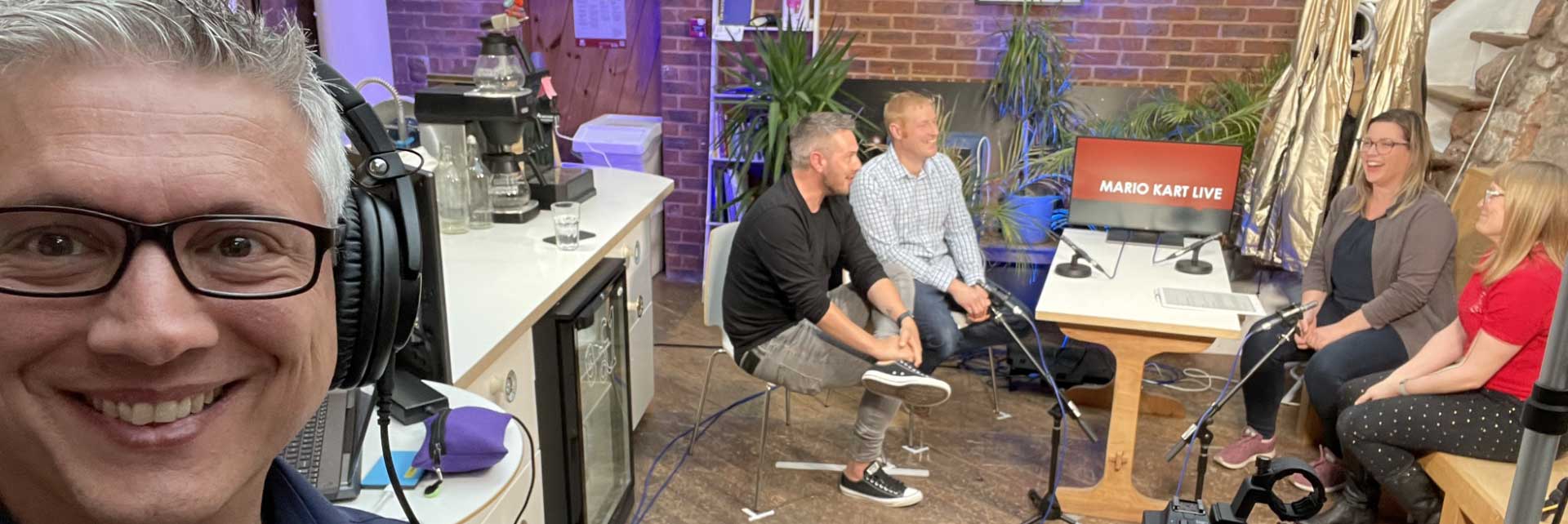 Panoramic picture of a studio setup with lights, video cameras and monitors
